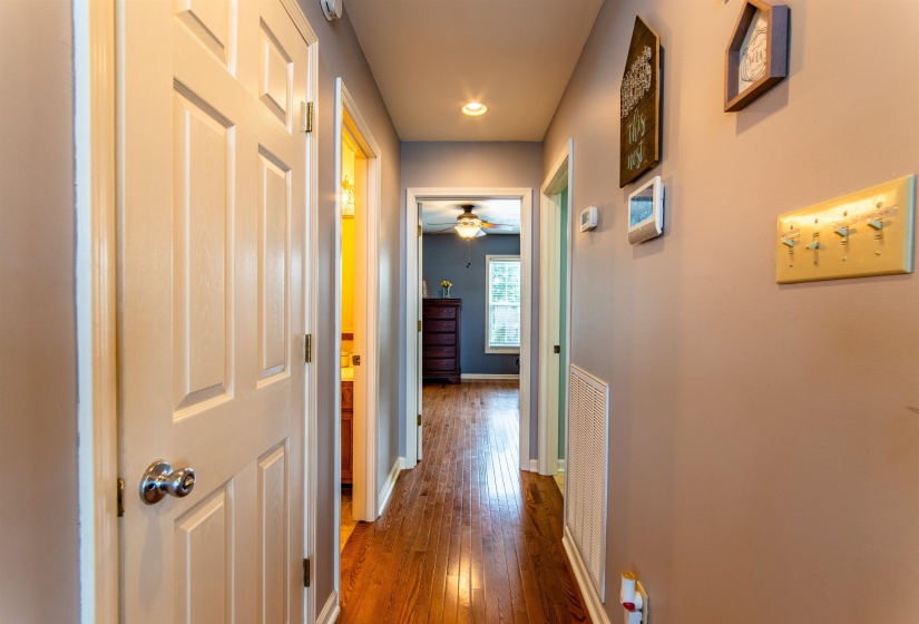 Hall featuring dark wood-style flooring and baseboards