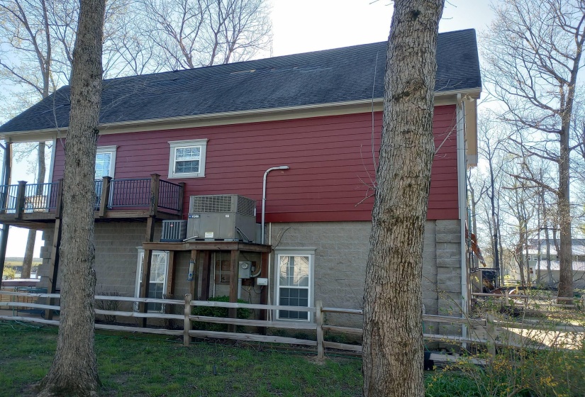 Side of property with roof with shingles and a deck