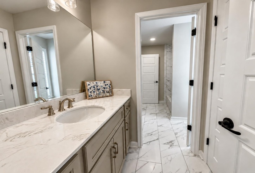 Adjoins BR 3 & 4 with separate vanities + shared tub/shower combo.