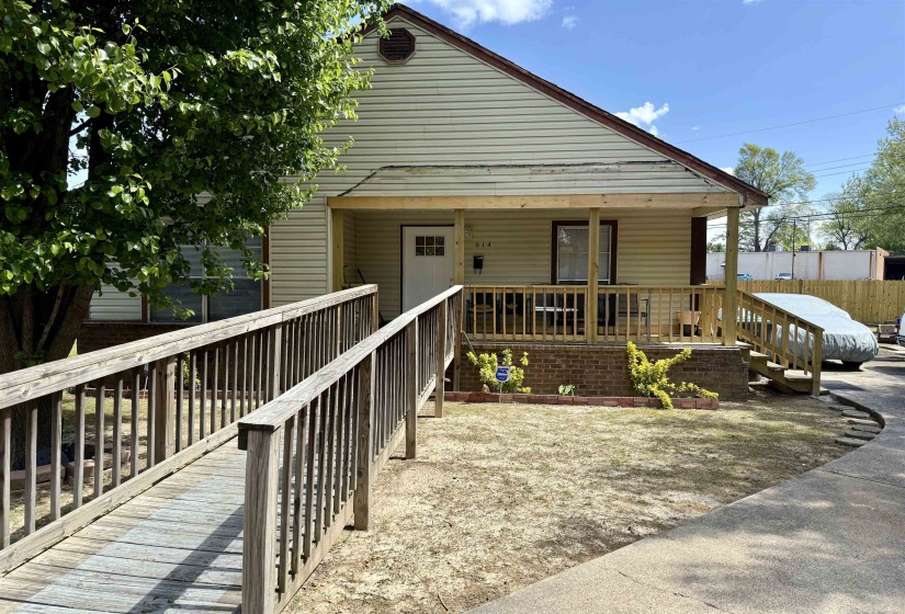 View of front of property with a porch and fence