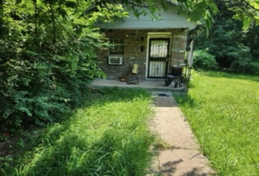 View of exterior entry featuring a yard