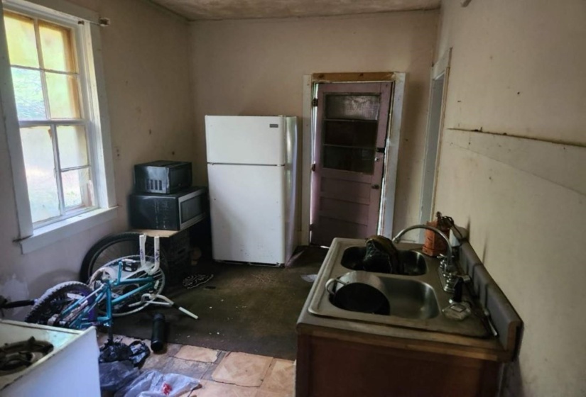 Kitchen featuring white refrigerator, sink, and a healthy amount of sunlight