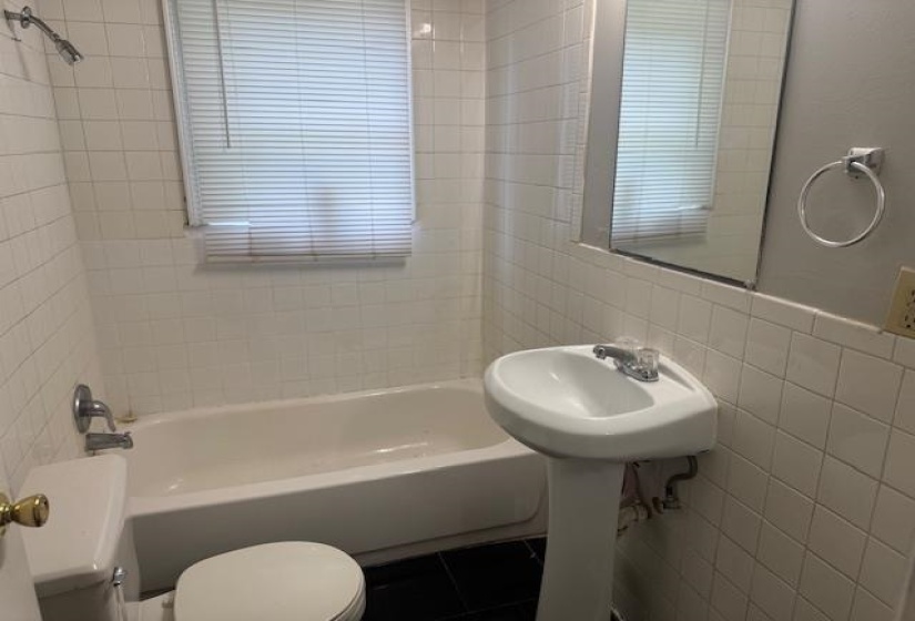 Bathroom featuring tile walls and shower / washtub combination