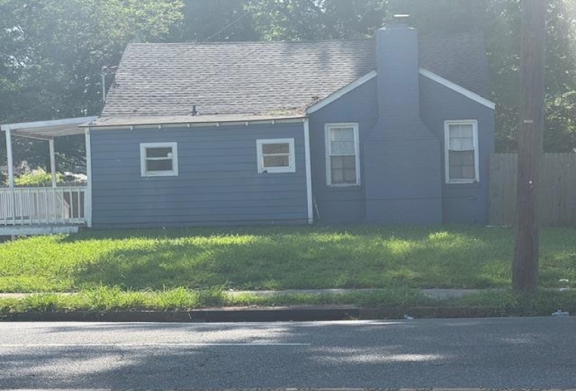View of property exterior with a chimney