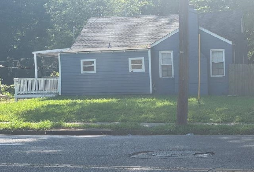 View of property exterior featuring a yard