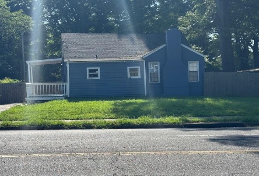 View of side of home featuring a chimney