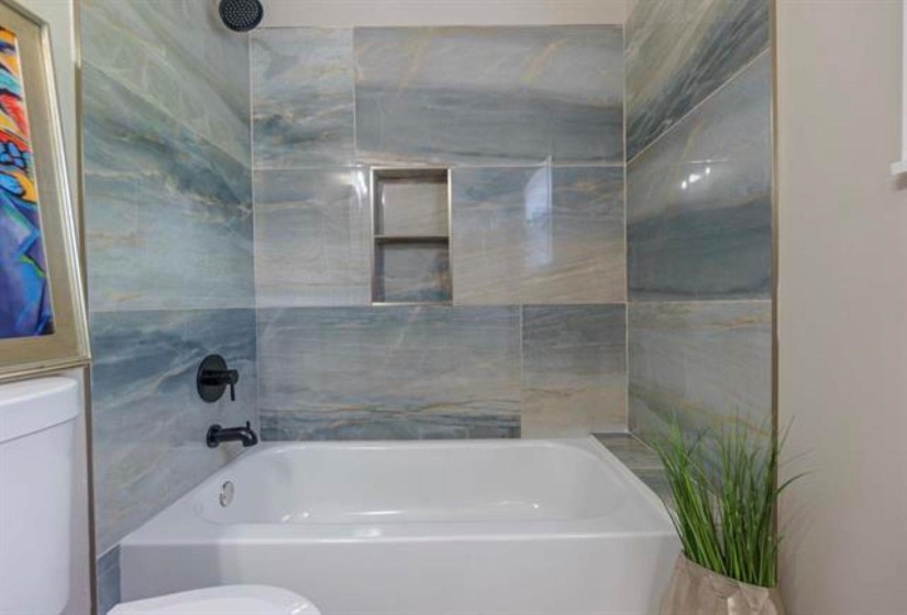 Full bathroom with toilet and bathtub / shower combination