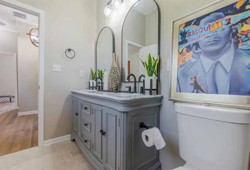 Bathroom featuring double vanity and light tile patterned floors