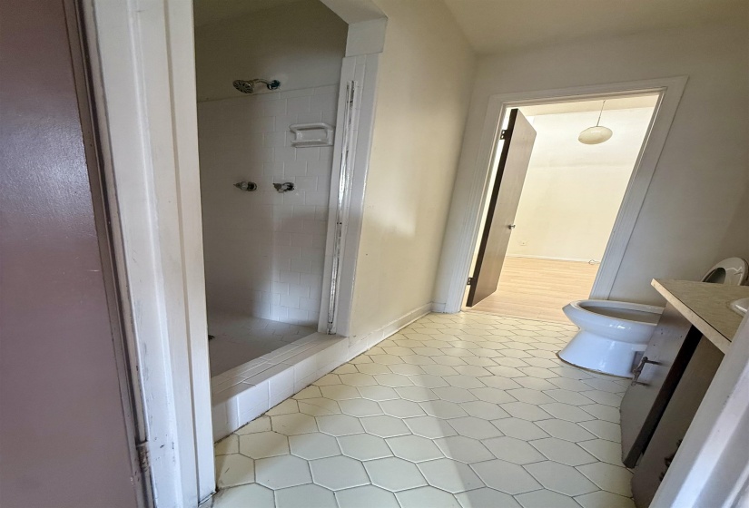 Bathroom with vanity, a shower stall, and light tile patterned flooring