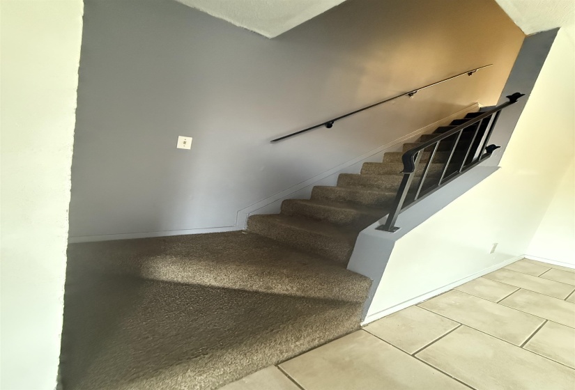 Stairs featuring tile patterned flooring and baseboards