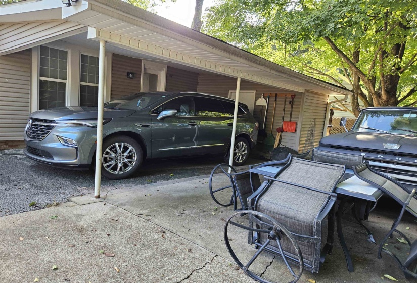 View of vehicle parking featuring an attached carport