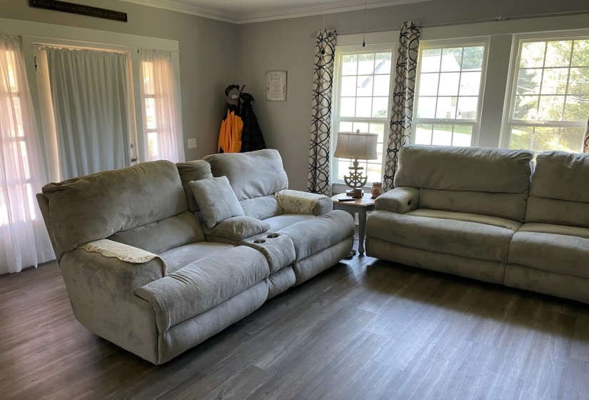 Living room featuring crown molding and wood finished floors