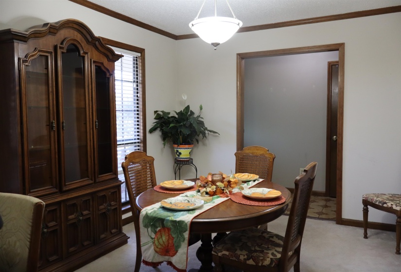 Dining space featuring crown molding and baseboards