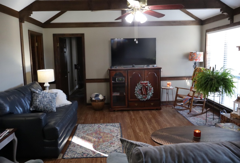 Living area with wood finished floors and ceiling fan