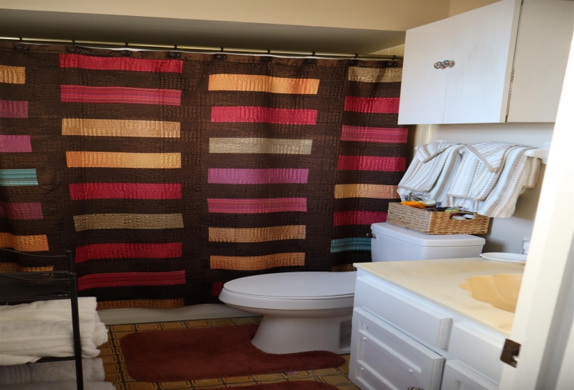 Full bath featuring vanity, a shower with curtain, and light tile patterned flooring