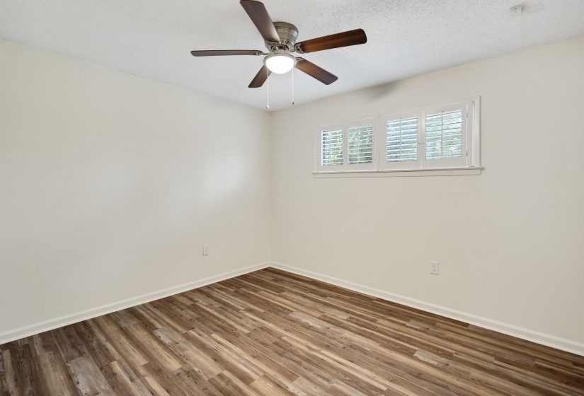 Unfurnished room with wood finished floors, a textured ceiling, and ceiling fan