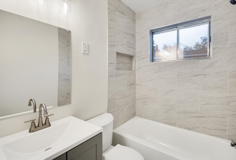 Bathroom with vanity and bathing tub / shower combination