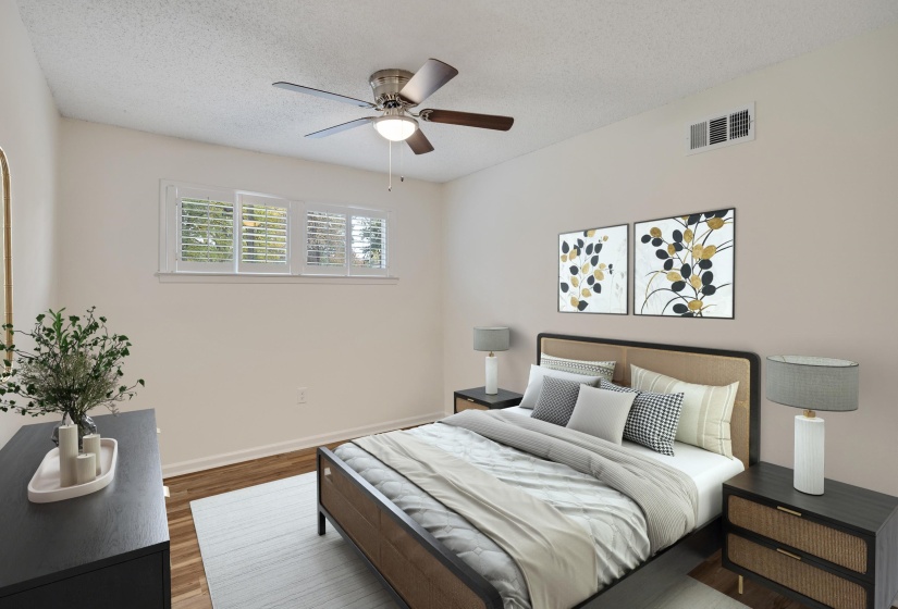 Bedroom with a textured ceiling, wood finished floors, and a ceiling fan