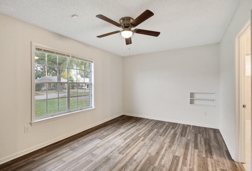 Unfurnished room featuring light wood-style floors, a textured ceiling, and ceiling fan
