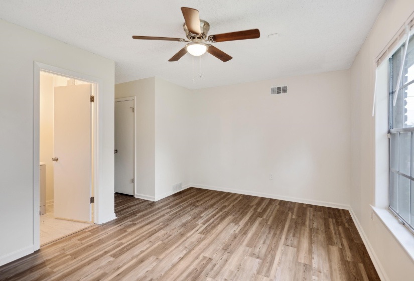 Empty room featuring light wood finished floors and ceiling fan