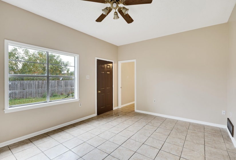 Spare room with a ceiling fan and light tile patterned floors