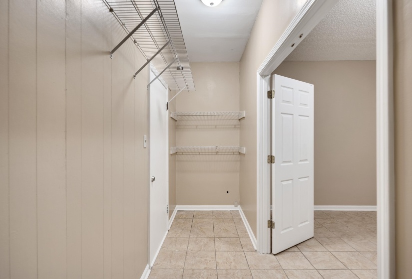 Walk in closet with light tile patterned flooring