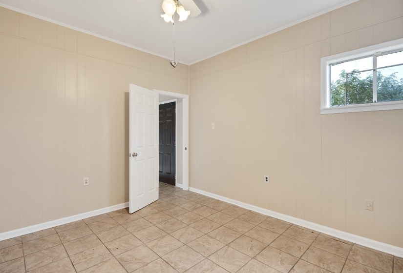 Unfurnished room featuring crown molding and wood walls