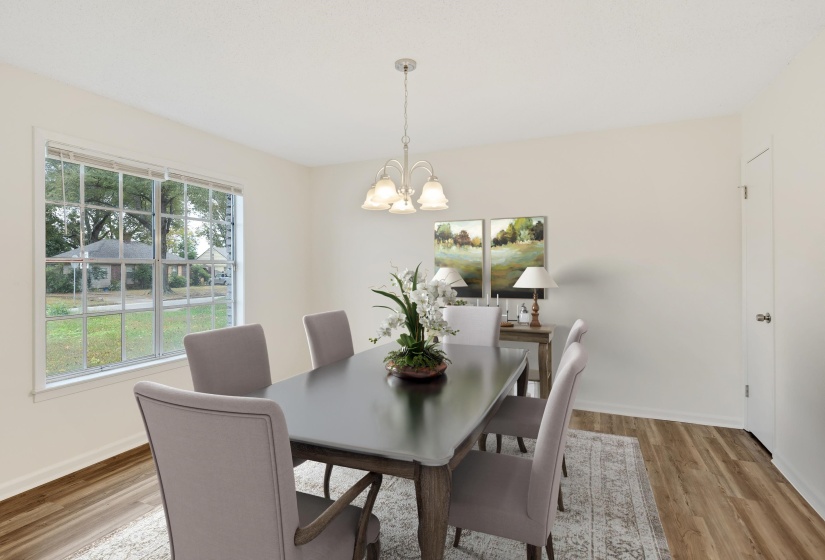 Dining space featuring light wood-style floors and a chandelier
