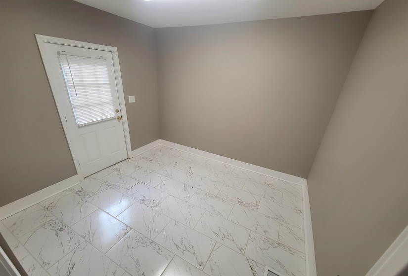 Unfurnished room with light marble finish floors and baseboards
