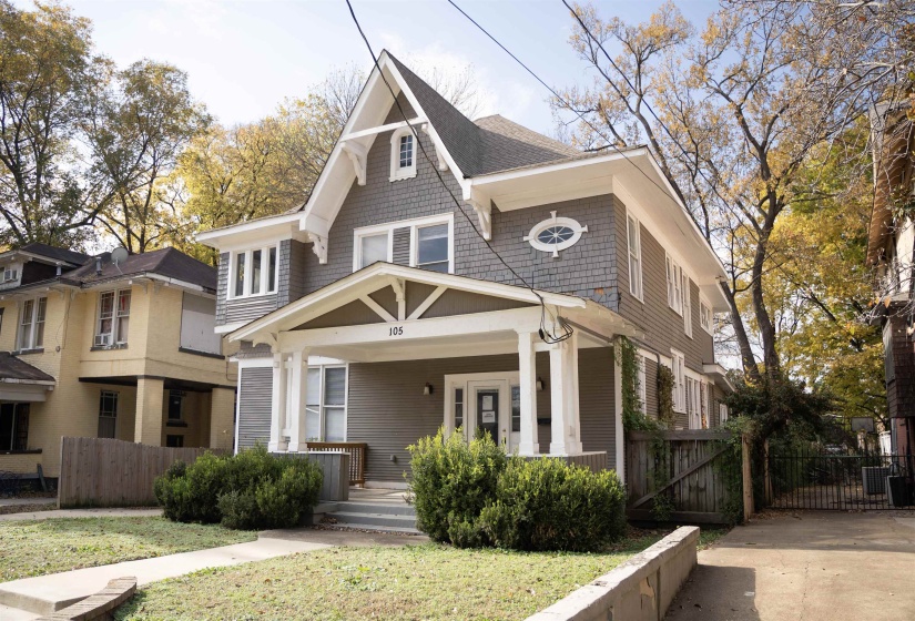 View of front of home with covered porch and a gate