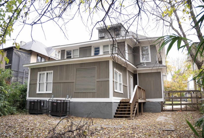 Back of property with a sunroom