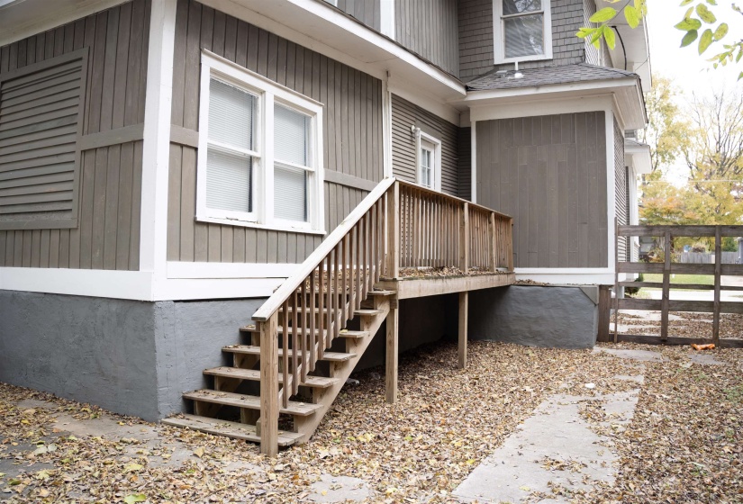 View of exterior entry with roof with shingles
