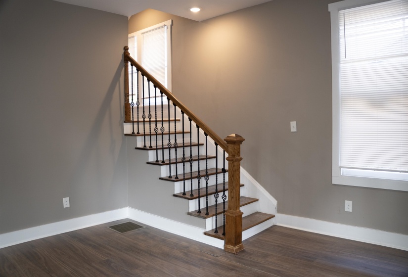 Stairway with baseboards and wood finished floors