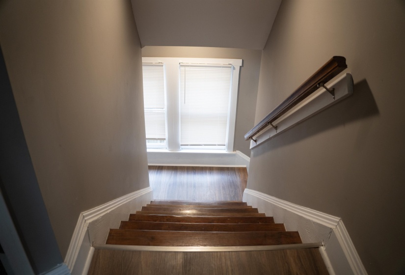 Staircase featuring wood finished floors and baseboards