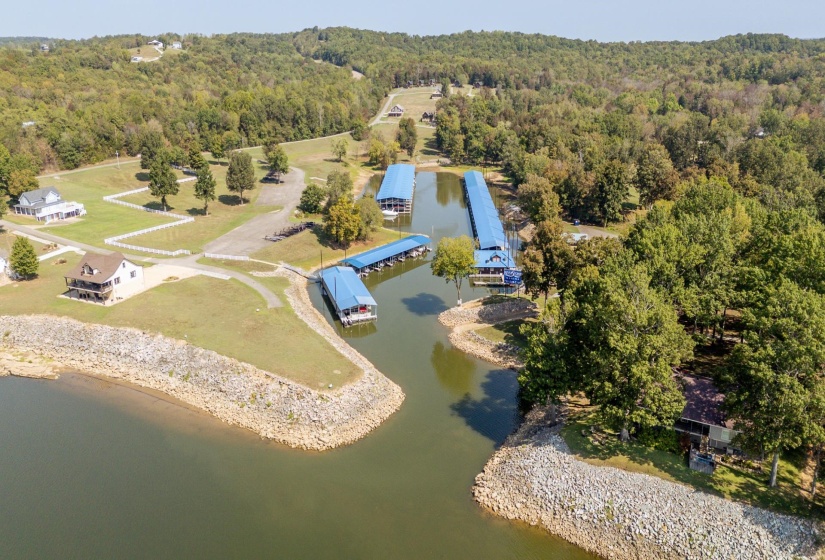 Drone / aerial view of a heavily wooded area and a nearby body of water