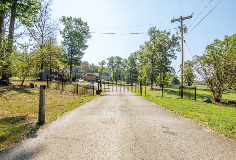 View of road with a gate and a gated entry