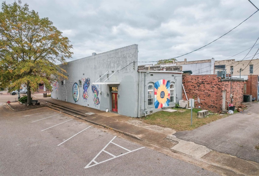 View of building exterior with uncovered parking