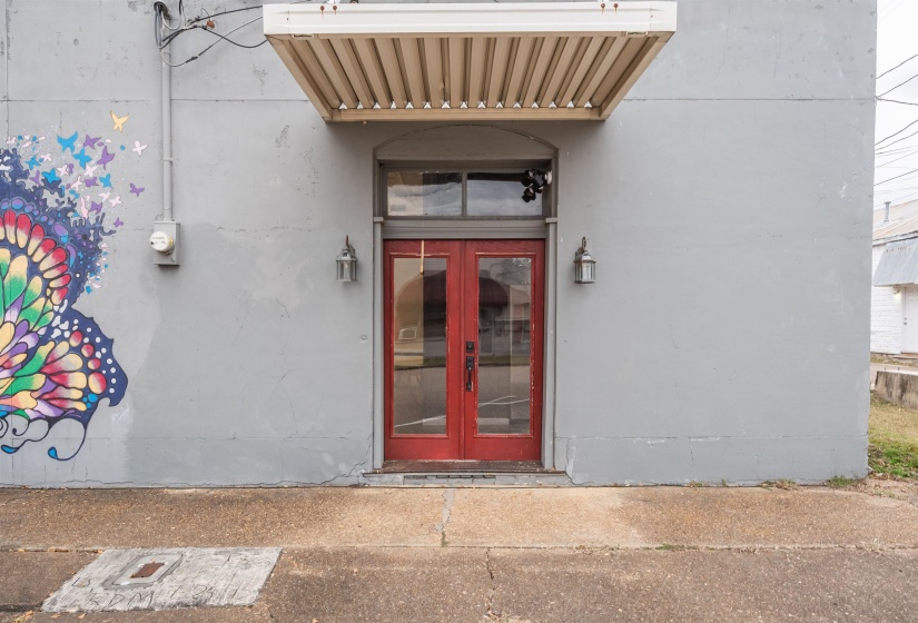 Entrance to property featuring french doors and stucco siding