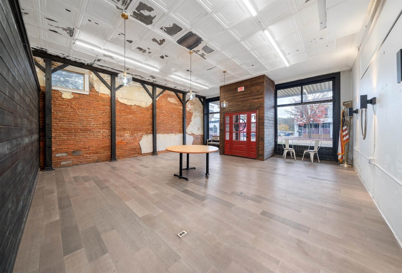 Common area with brick wall and an ornate ceiling