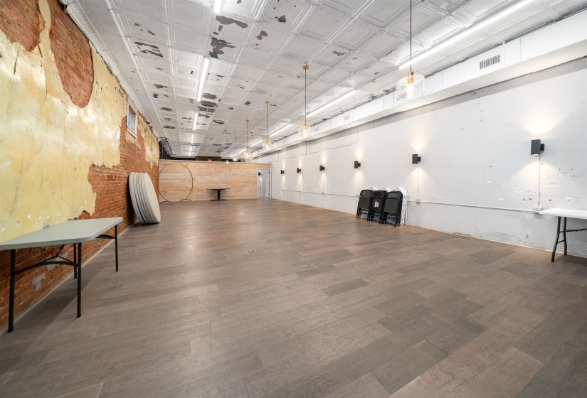 Miscellaneous room featuring an ornate ceiling and brick wall