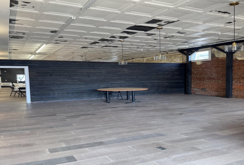 Misc room with wood finished floors, an ornate ceiling, and wooden walls