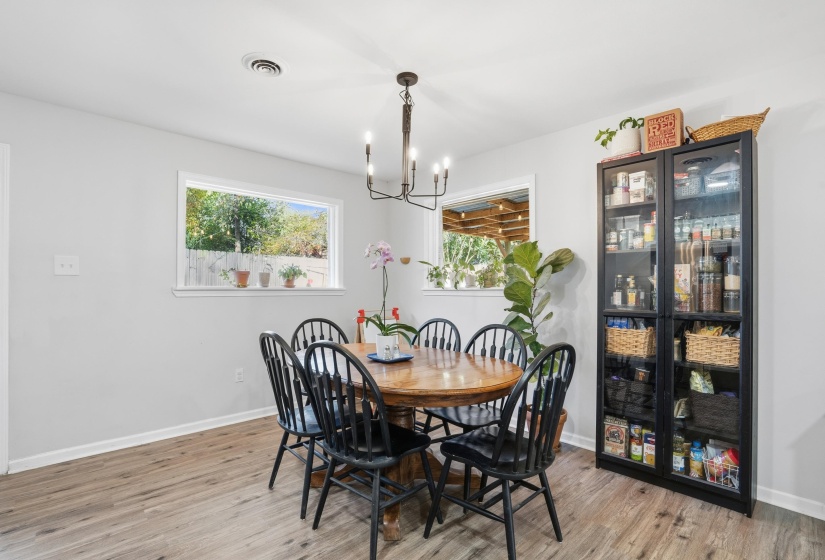 Dining space featuring light wood finished floors and a chandelier