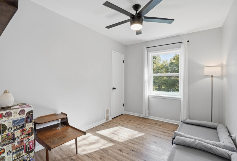 Living area featuring light wood-style flooring and ceiling fan