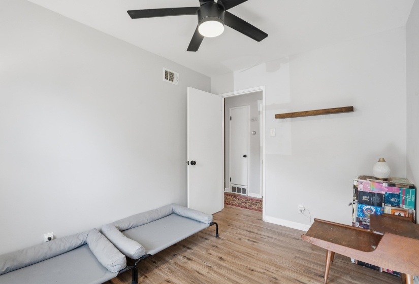 Sitting room with light wood finished floors and ceiling fan