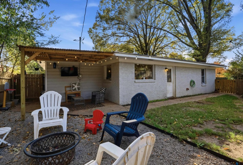 Back of house featuring a patio area, brick siding, and a fire pit
