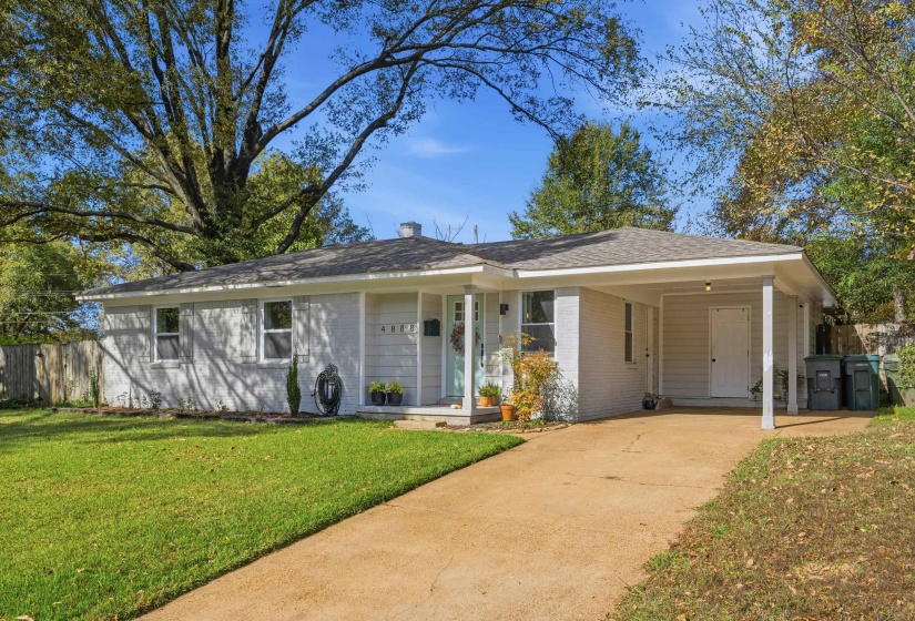 Ranch-style home with brick siding, an attached carport, concrete driveway, and roof with shingles