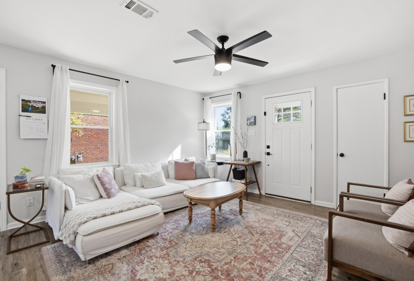 Living room featuring wood finished floors and ceiling fan