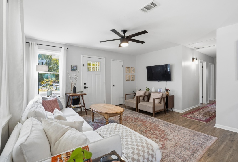 Living area with wood finished floors and ceiling fan