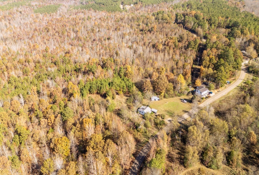 Aerial view of property's location with a forest