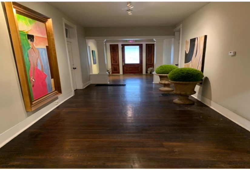 Hall with dark wood-style floors and ornate columns